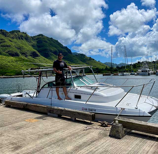 Capt. Austin standing on Aloha Kauai Sportfishing's boat "Malolo"